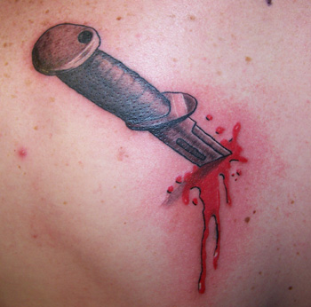 Tattoos knife in back